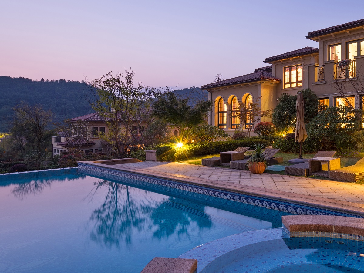 Evening shot of a beautiful vacation home from the pool.  Vacation homes. Find new places to call home.